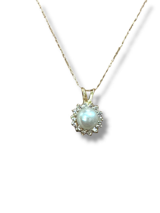 Gold necklace with a pendant featuring a pearl 