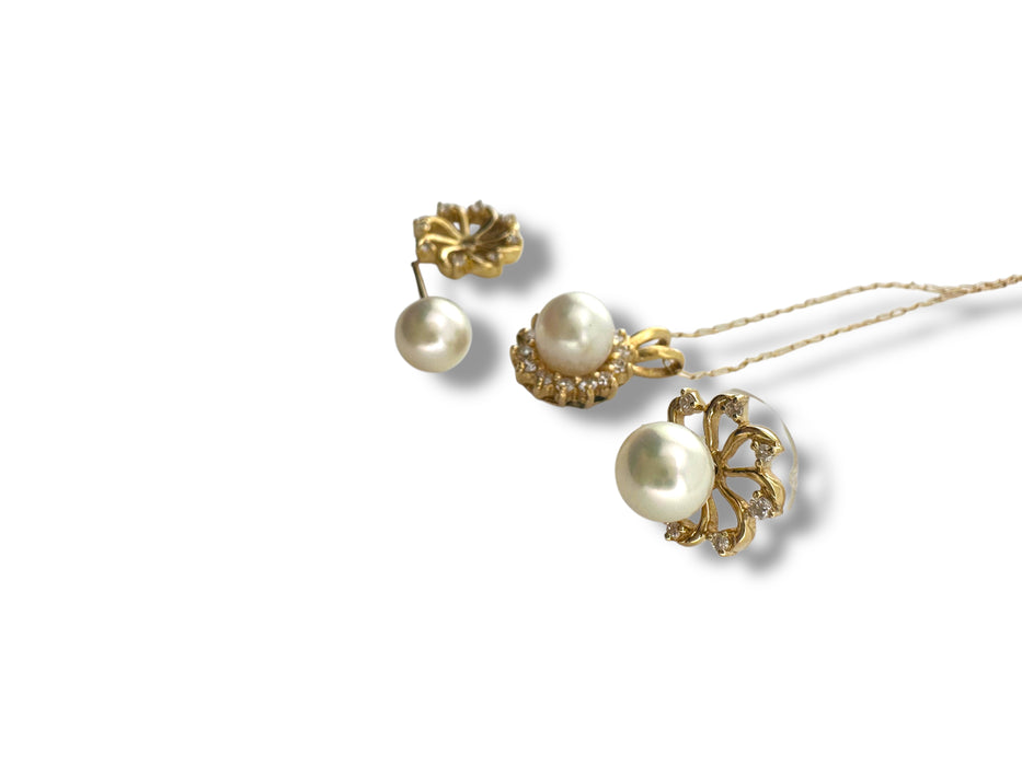 Gold earrings with pearls on a white background